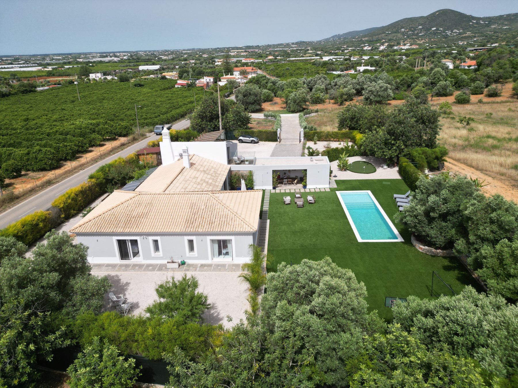Vale da Rosa, Estoi — aerial view of the house, pool and surrounding olive groves looking south