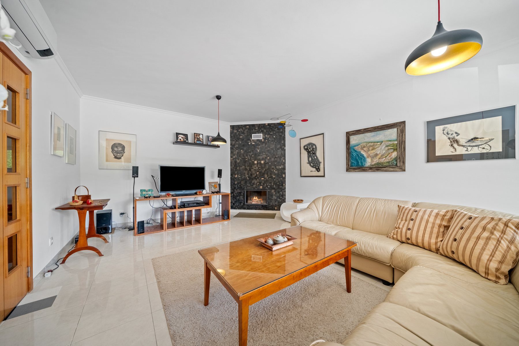 Tavira townhouse — open living and dining room with fireplace